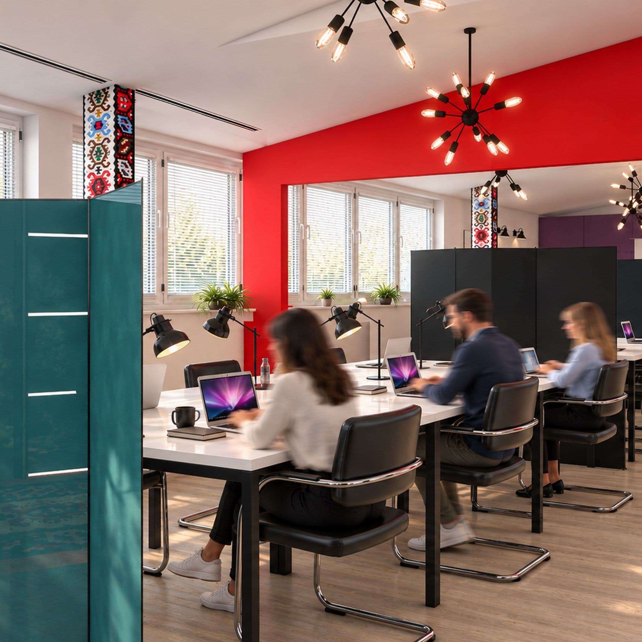Workstations with black chairs, a teal cabinet and a red feature wall