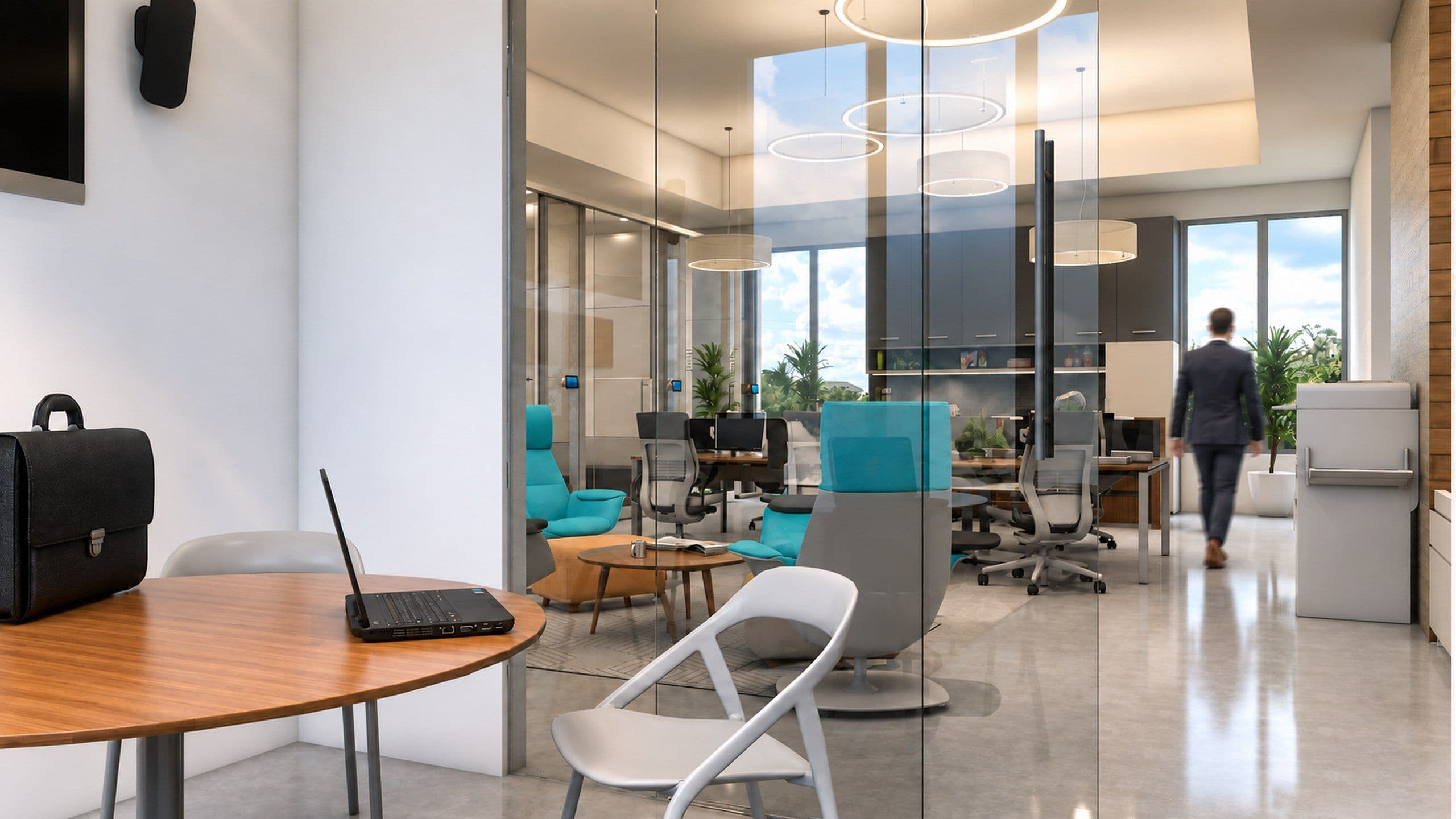 Glass walled consultation room beside the open plan desks