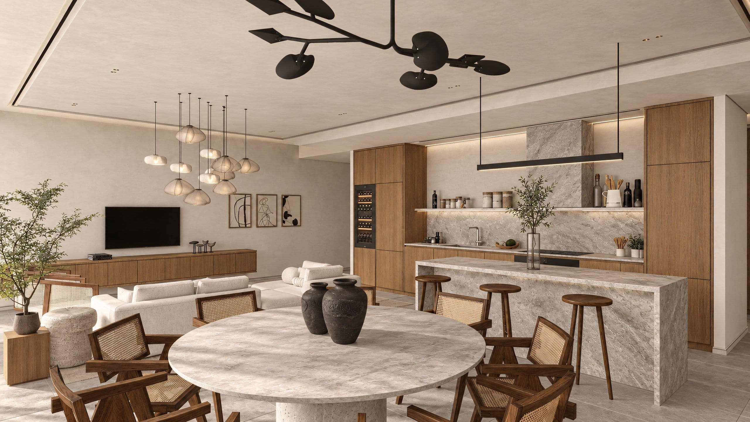 Open plan living and dining space with a round marble table, cane chairs and a marble island