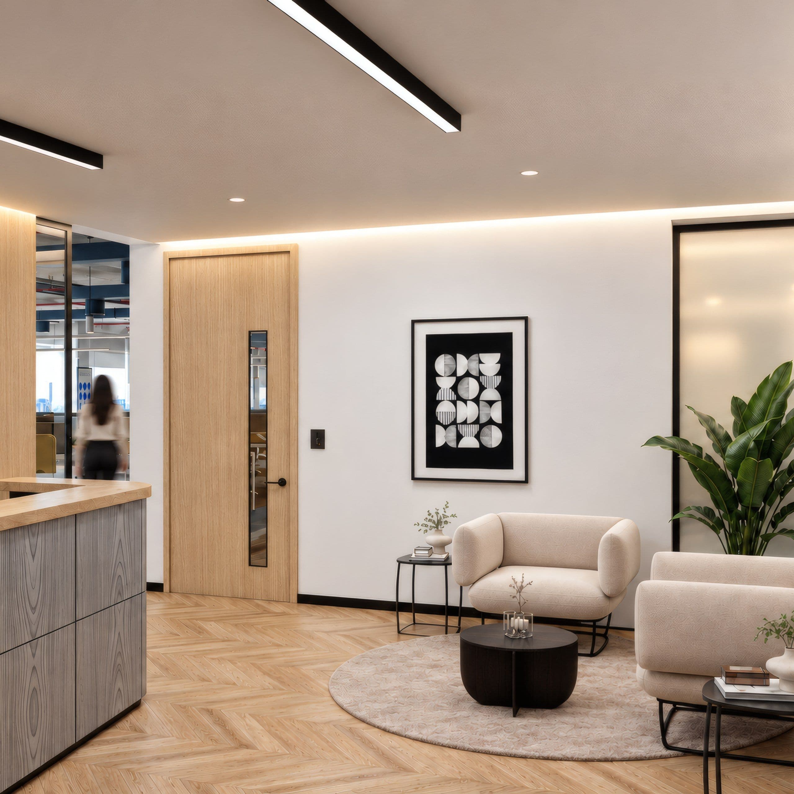 Reception lobby with a timber door, a herringbone floor and cream armchairs