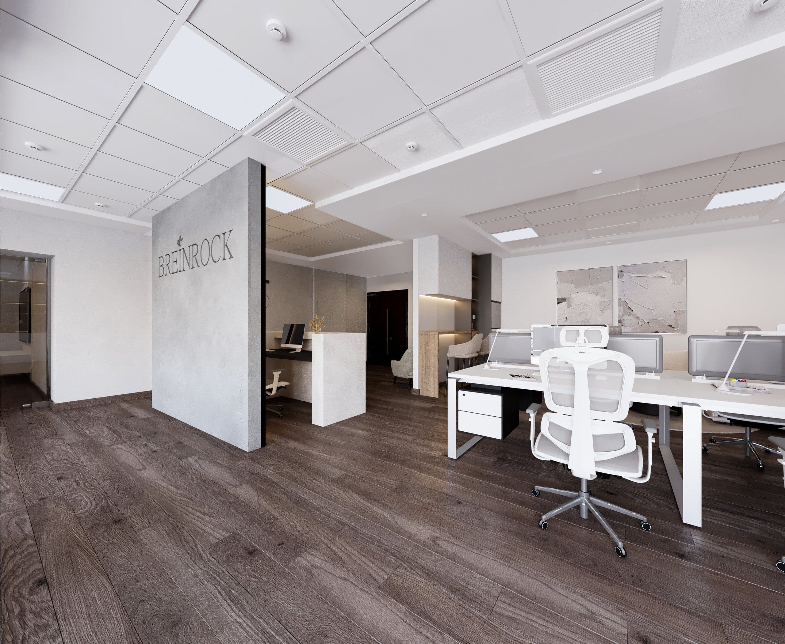 Open office with a white partition carrying the Breinrock logo and rows of workstations